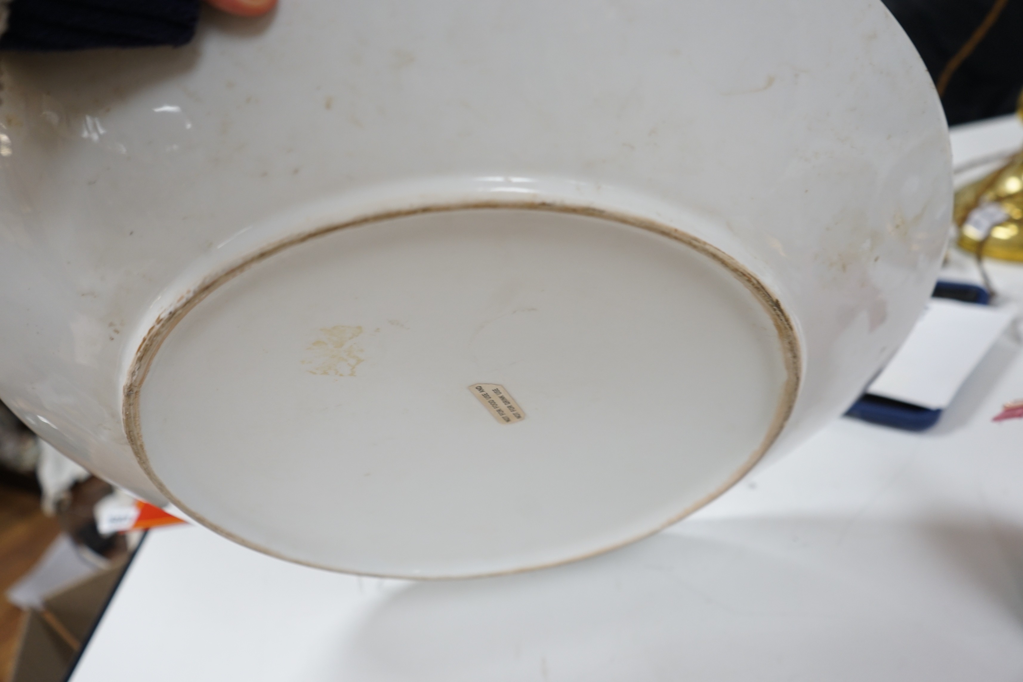 A large gilt and black pottery charger, 50cm diameter